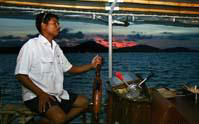 Captain drives June Bahtra Sunset Dinner Cruise into Phang Nga Bay
