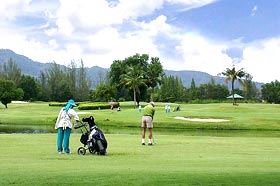 Picture of green course with player at Laguna Phuket Golf Club